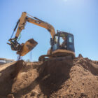 Excavator Tilting Bucket Digging Dirt - Rockland Manufacturing